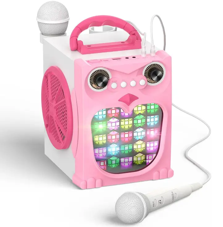 Pink owl-shaped EARISE K25P karaoke machine with a glowing multicolor LED belly, a carry handle on top and two white wired microphones